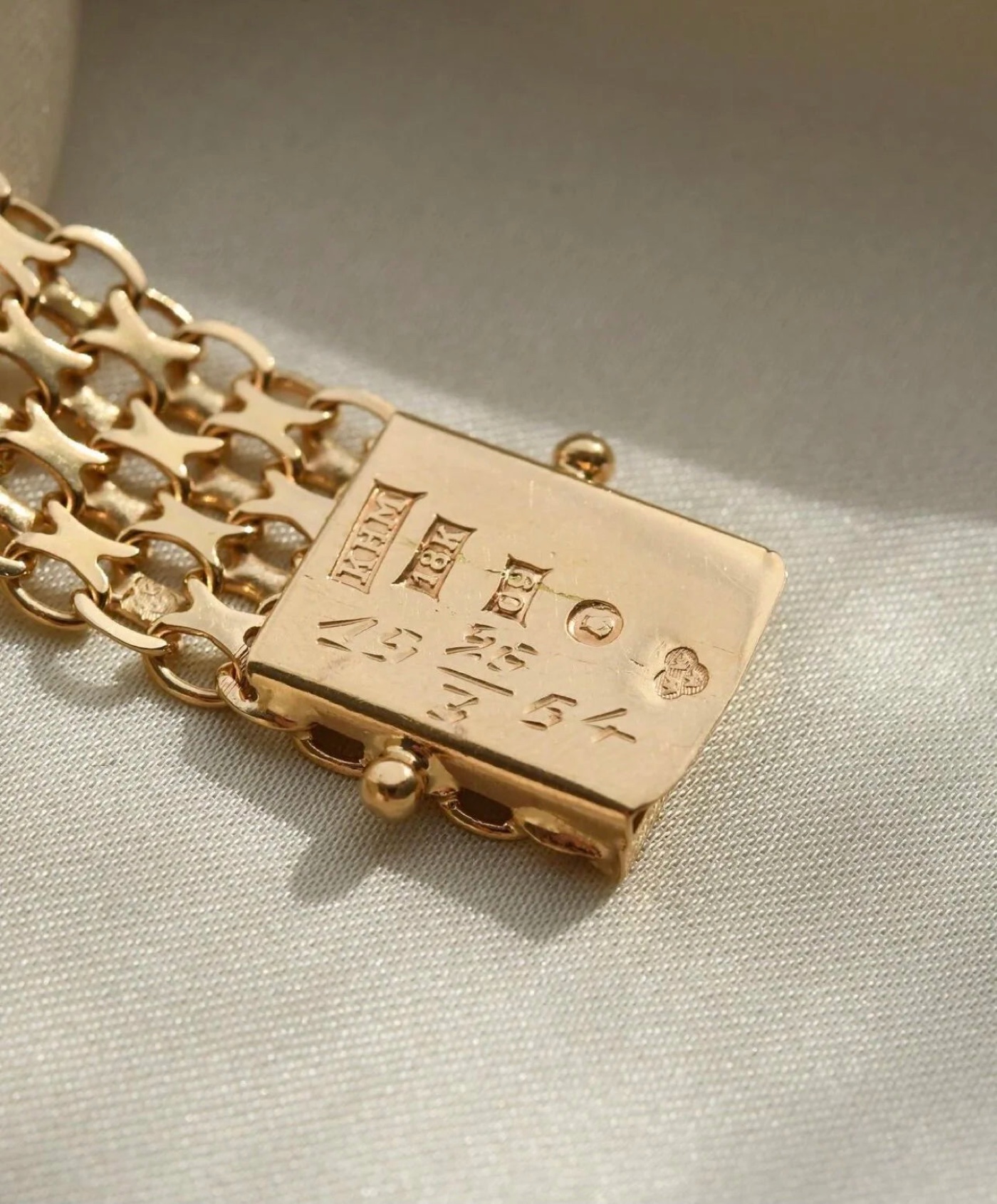 A full Swedish row on a bracelet clasp: maker, fineness, town, and the date code that names the year. Photographed from a piece in the Oldmine collection.